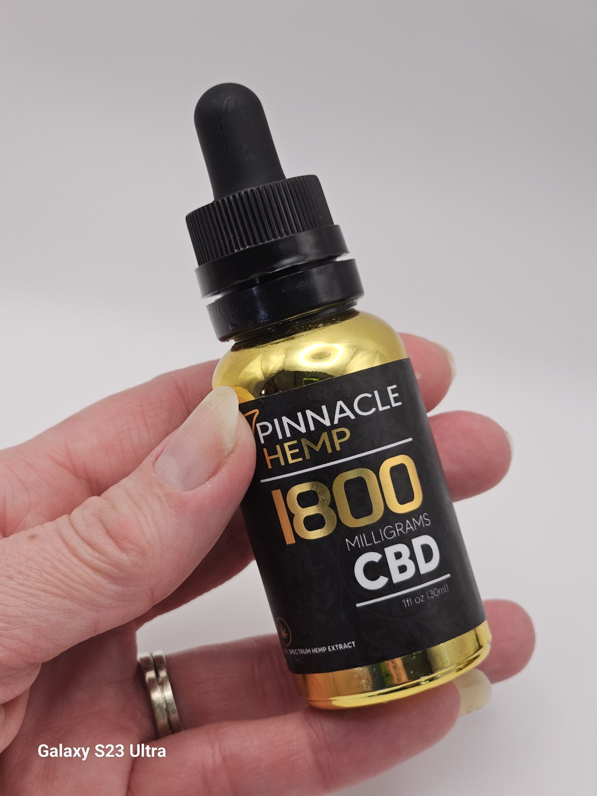Pinnacle Hemp Original Hemp Tincture 1800mg full-spectrum CBD bottle standing on a dark background