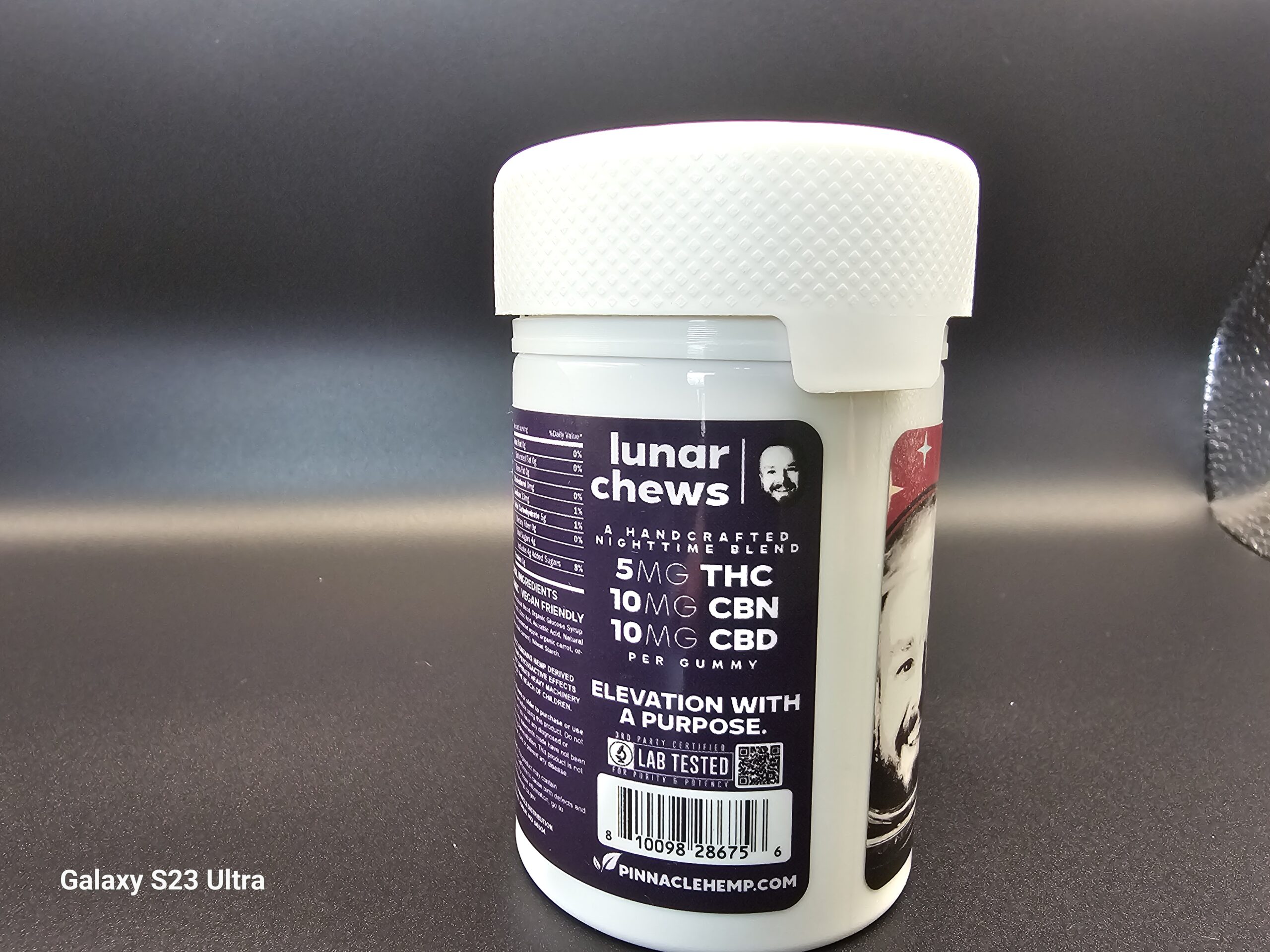 Close-up of the back label on a Stoner Gump Lunar Chews bottle showing cannabinoid amounts and ingredient information