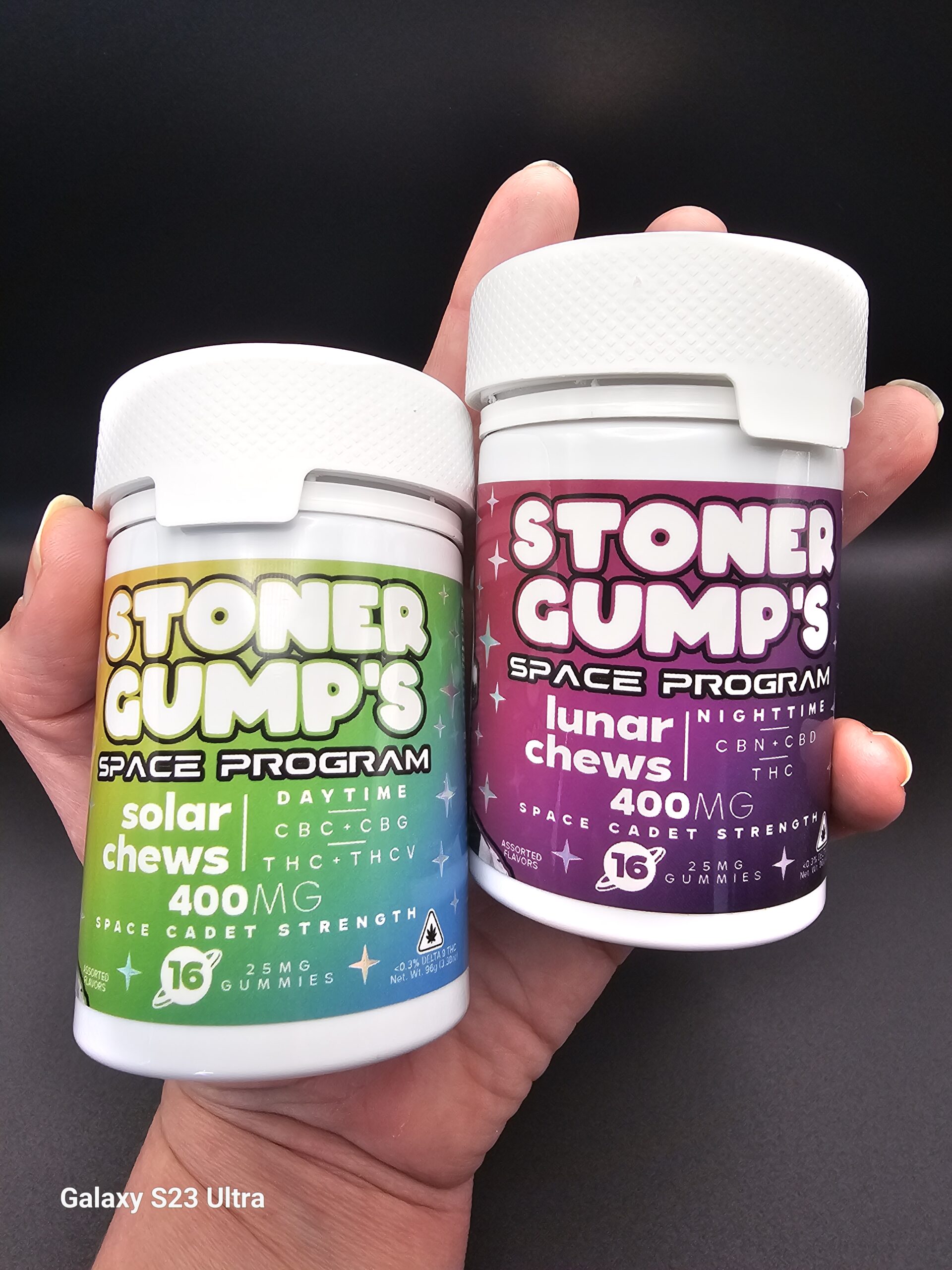 Close-up image of Stoner Gump Solar and Lunar Chews bottles held side by side in a hand